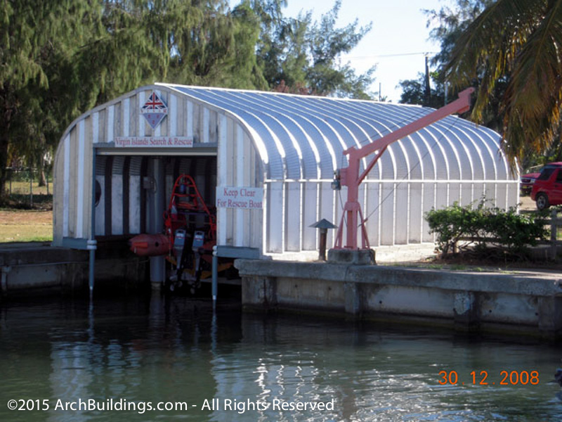 A steel arch building is used as a dock for search and rescue boat storage
