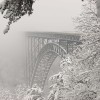 Metal building arch style trails off into the fog of snowfall.